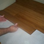 Inserting the tongue into the groove is easy when it's at the correct angle. Notice the shim against the wall.
