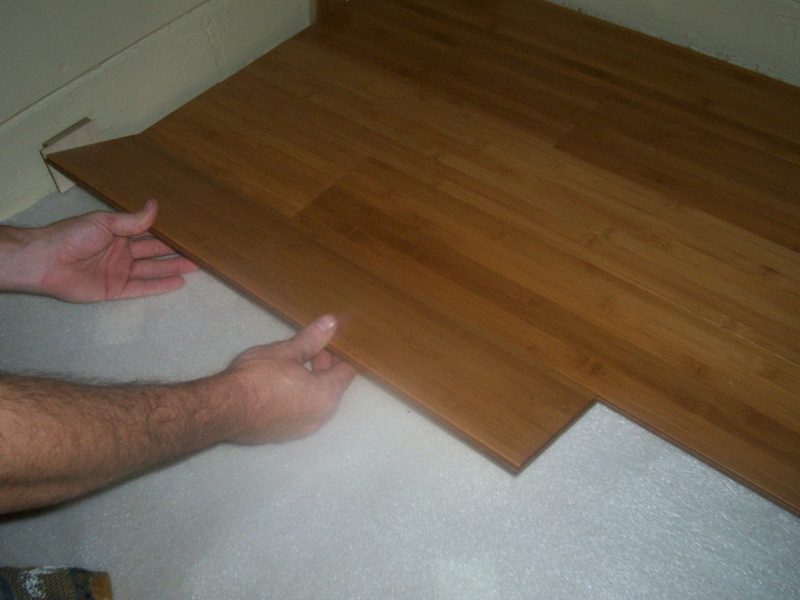 Inserting the tongue into the groove is easy when it's at the correct angle. Notice the shim against the wall.