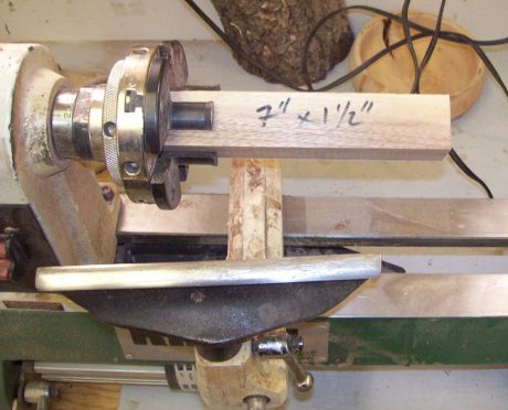 A walnut blank mounted in a four jaw chuck, ready for turning.