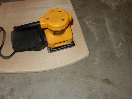 hand sanding wooden seats