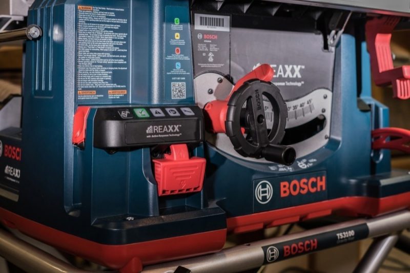 The red paddle to the left of the indicator lights is held in while the saw is powered on to enable bypass mode. Fingers beware!
