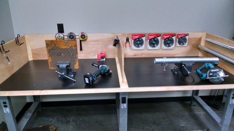 training center lab station with grinders and steel tubing.
