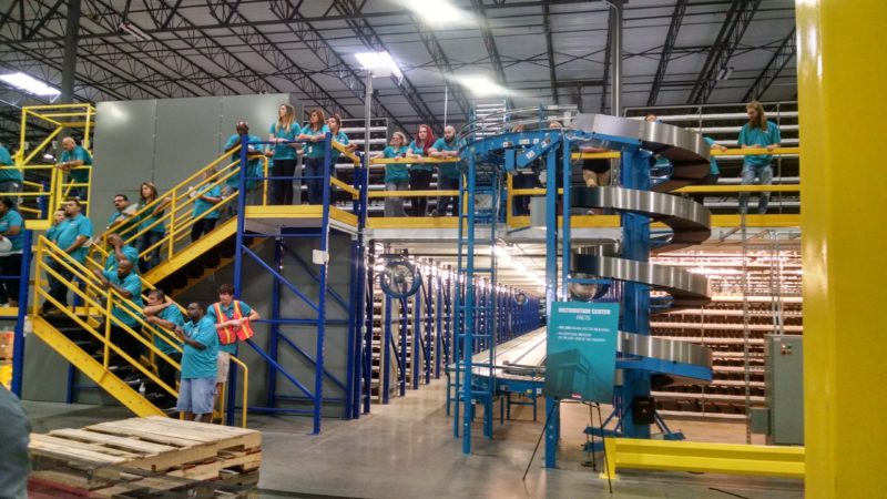 employees on stairs and packing area mezzanine