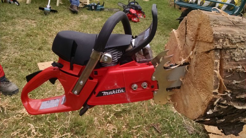 Makitas largest gas chain saw stuck into cut in log