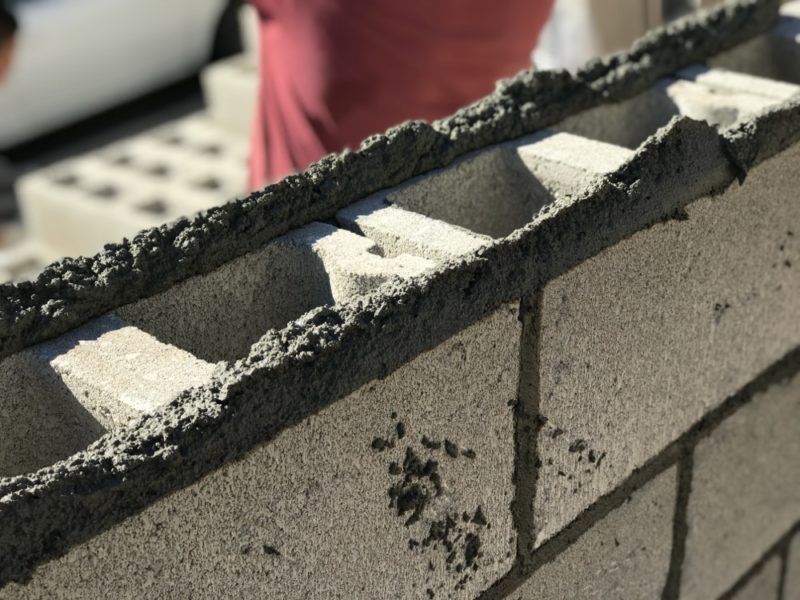 applying the mortar to the concrete blocks