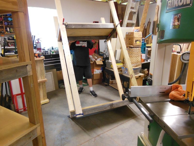 Righting the heavy duty shelving unit.