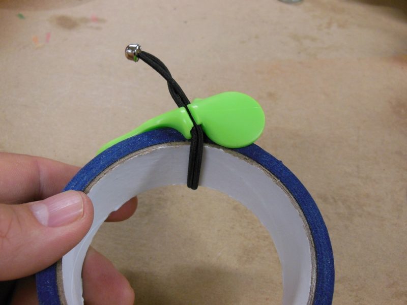Tadpole straps onto your tape roll.