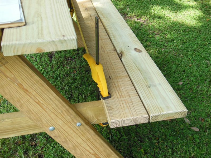 Bench slats clamped to picnic table.