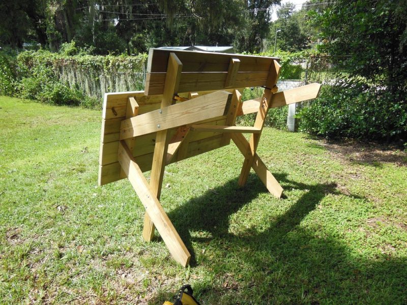 Picnic table stood on edge.