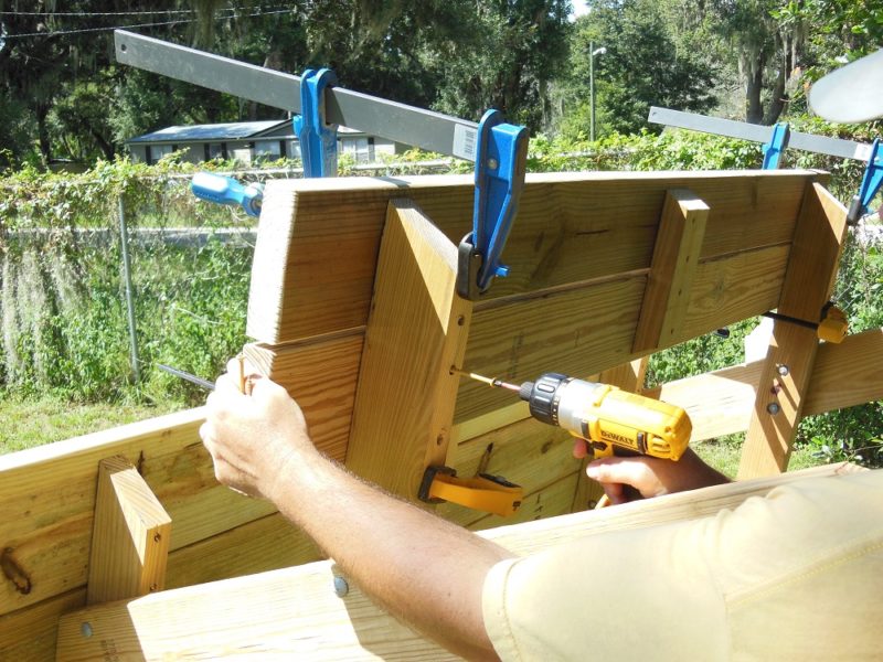 Screwing the bench slats in place.