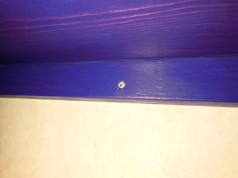 Screwed to the wall.