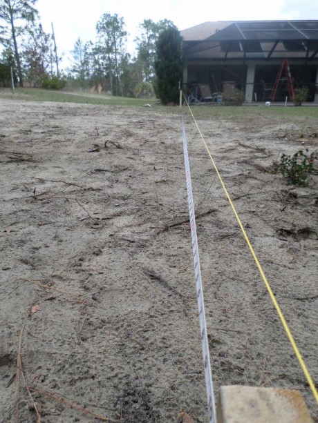 After the permit was in hand, we broke ground quickly. Here, we use the pool cage and house as a reference to layout the garage